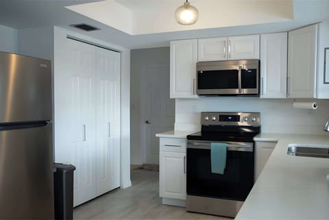 ""Open-concept kitchen and dining area, where cooking and conversations flow seamlessly."