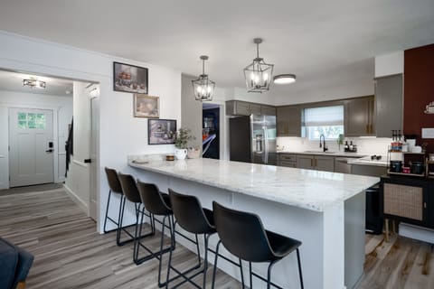Fully stocked kitchen with a spacious bar overlooking the living area