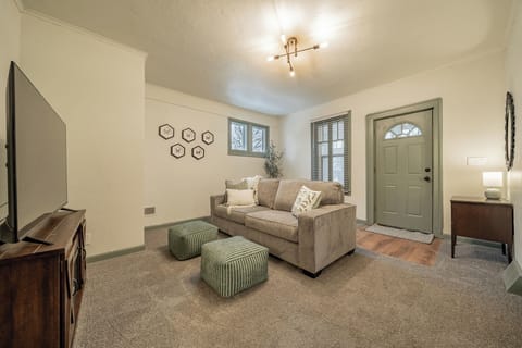 - Cozy living room with neutral tones and stylish green accents for a calm stay   - Smart TV and soft carpet for relaxing movie nights or work breaks   - Natural light and modern lighting create a warm inviting atmosphere