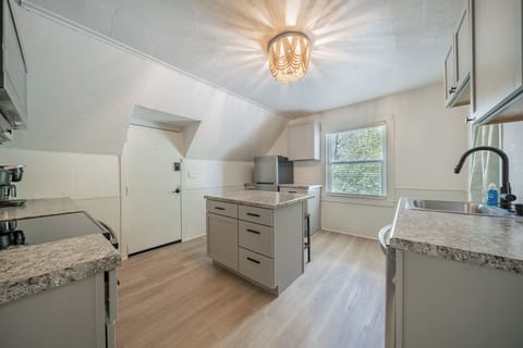 - Bright kitchen with island seating and modern appliances for easy meal prep   - Natural light fills this updated space creating a fresh inviting cooking area   - Ideal setup for guests seeking a clean functional and well equipped kitchen
