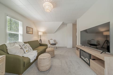 - Bright living room with comfy seating   - Relaxing space with TV and soft natural light   - Perfect for cozy evenings during your stay