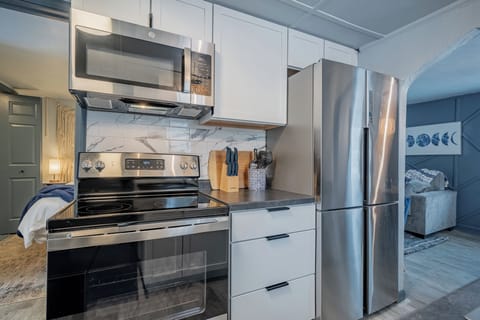 - Modern kitchen featuring stainless appliances and a clean updated cooking area - Smooth counters and organized essentials make meal prep simple for guests - Ideal setup for travelers wanting a ready to use functional kitchen