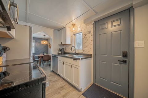 - Bright kitchen entry with updated cabinets stainless appliances and modern finishes - Natural light fills this functional cooking space ready for guest use - Easy access to dining and living areas creates a smooth stay flow