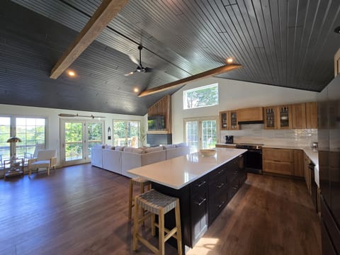 - Spacious open living and kitchen layout for groups   - Large windows fill the home with natural daylight   - A warm inviting hub perfect for cooking and lounging