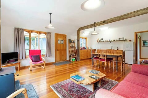 The warm, open-plan living and dining space features a slow-combustion fireplace to keep you cosy indoors and opens to a verandah that soaks in rural vistas and dazzling sunsets. 