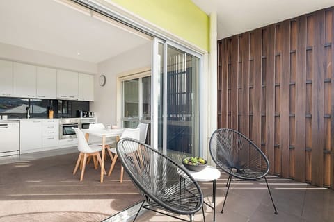 Sliding doors extend from the open plan living area out to the private balcony.