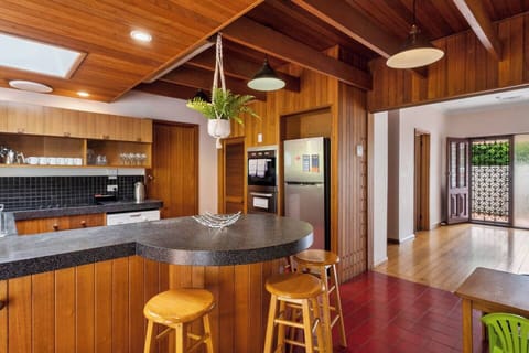 The retro kitchen is cladded in timber and fully-equipped for your holiday catering.