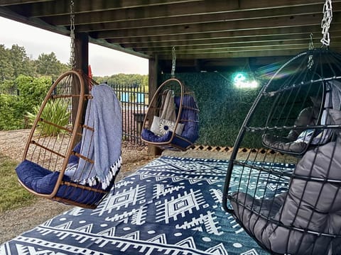 Under the deck there are 4 swinging egg chairs overlooking the back of the property.