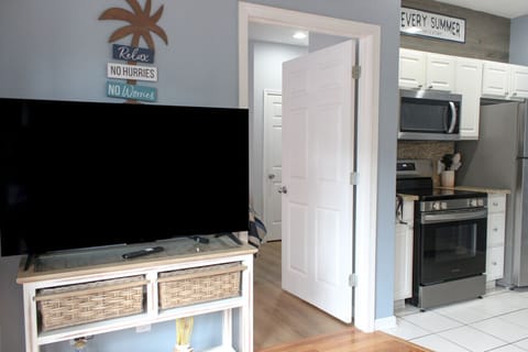 Living Area TV & Partial View of Kitchen