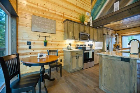 Enjoy a cozy breakfast nook by the back window, perfect for morning coffee or a quiet meal. The kitchen blends modern appliances with rustic charm, offering everything you need to feel right at home.