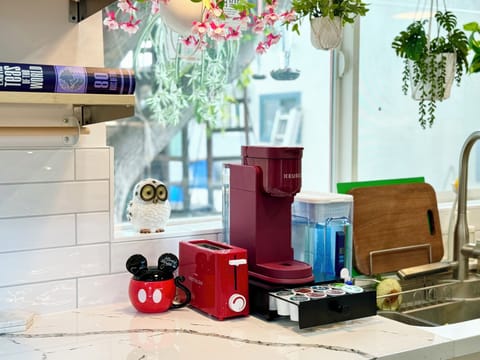 Coffee corner with a Keurig, toaster, and charming Mickey Mouse decor.
