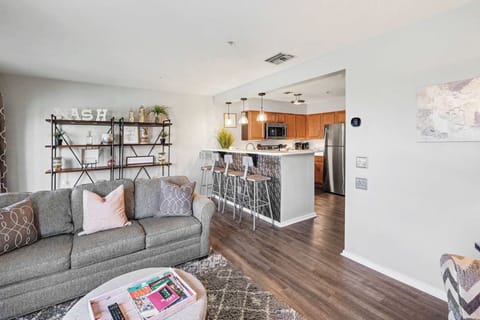 Bright living area with full sofa sleeper, electric fireplace, and TV