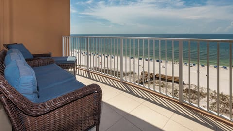 Unwind on the balcony lounger as gulf air drifts by and watch beach umbrellas dot the shore