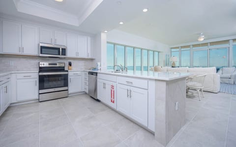 Prepare meals in this kitchen with elegant cabinetry, stainless appliances, and spacious countertops