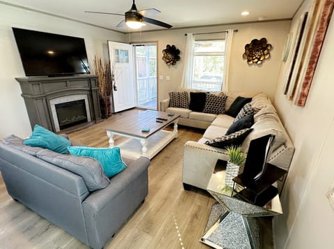 L shape living room plus sofa bed, Smart TV with fire stick and fireplace.