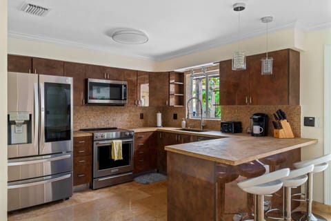  Fully equipped kitchen with sleek stainless steel appliances for a seamless and sophisticated culinary experience.