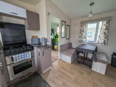 Cozy kitchen and dining nook with natural light and modern comforts