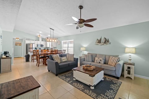 Large living room with a sleeper sofa, loveseat, coffee table, and Smart TV