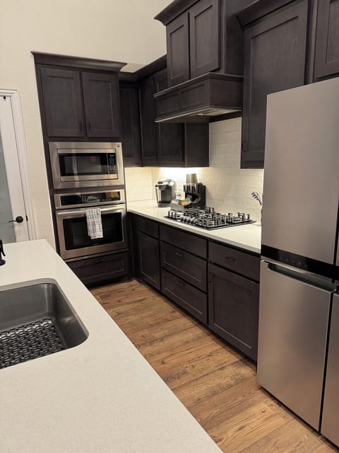 Another view of the kitchen, professional oven microwave, and cooking equipment