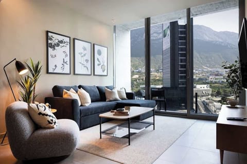 Floor-to-ceiling windows frame stunning mountain scenery.