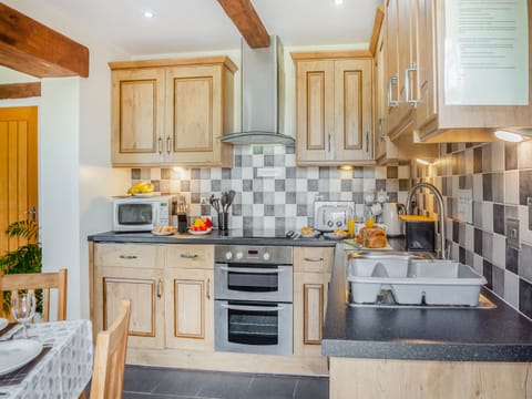Kitchen/diner | Bryn Awelon Bach - Moelfre Cottages, Moelfre, near Benllech