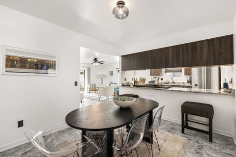 Open kitchen & dining space w/ island seating, modern finishes, and room to gather over shared meals.