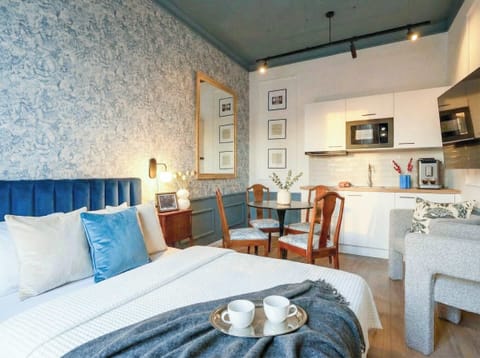 First bedroom with queen size bed and kitchen