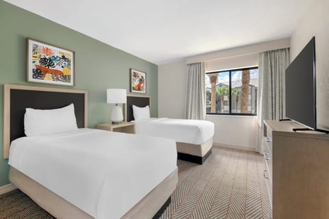Relax in a cheerful twin room with sunny window light.