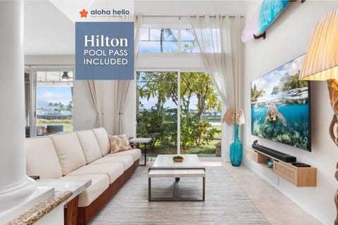 Hilton Pool Pass - FREE with stay for 6 adults (+ kids under 5) includes access to resort pools, lazy river, waterslides, hot tub, saltwater snorkeling lagoon, lounge chairs, towels, and parking for one vehicle.
