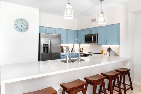 Prepare meals in a fully stocked kitchen, then step out onto the lanai to enjoy your food with views of the surrounding tropical landscape.