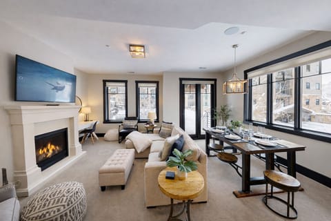 Cozy up by your crackling fireplace while winter views frame your elegant retreat, complete with plush seating and modern comforts.