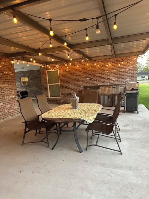 Outdoor grilling space with table and six chairs