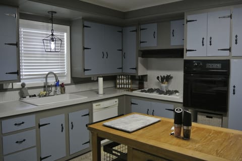 Kitchen with gas stove, microwave above the oven
