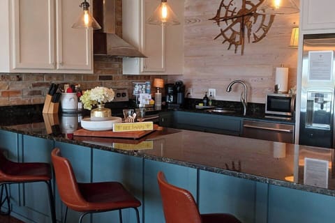 [Kitchen] Fully stocked and equipped kitchen. Keurig Carafe and Pod Coffee Maker -- pods supplied. Quality pots, knives and utensils for the gourmet chef.