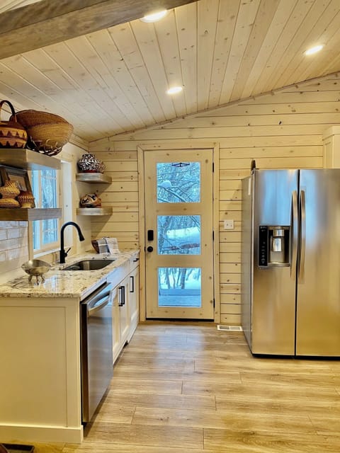 A full kitchen with granite waterfall peninsula with extra seating and gas range