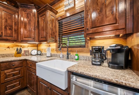 Clean-up is easy with this farmhouse sink, while the ample counter space and storage make cooking here a delight. It’s a kitchen designed for convenience and style.
