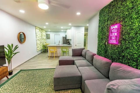 Relax in our stylish living area, complete with a comfy sectional sofa and vibrant accent wall.