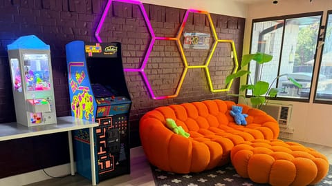 Arcade room with claw game and Pac-Man multi game, there is also a 65" TV 