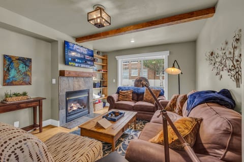 Living Room: Couch w/pull out bed, 43” Smart TV w/cable, gas fireplace, open layout
