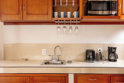 Fully stocked kitchen with sink, fridge, microwave, stove, water dispenser, etc.