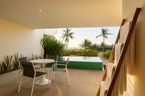 Relax in this open-air lounge with stunning ocean views, featuring a private plunge pool and seamless indoor-outdoor living for the ultimate tropical getaway.