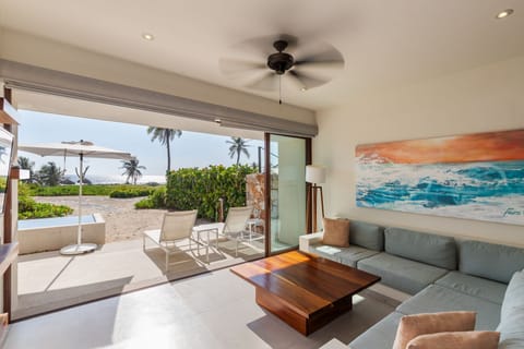 Relax in this beautifully designed indoor-outdoor lounge area, featuring ocean views, modern decor, and a cozy sectional.