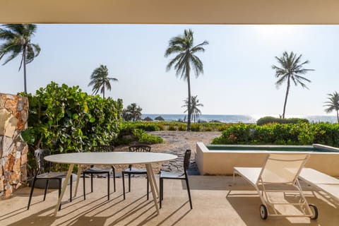 Relax on the shaded patio with stunning beachfront views, perfect for enjoying morning coffee or sunset cocktails.