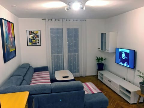 Living room with Smart Google TV 55", sofa and desk for work 