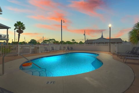 A beautiful community pool, beautifully lit up at night, creating a serene and inviting atmosphere for evening swims and relaxation.