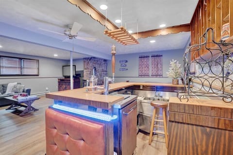 Vibrant Bar & Entertainment Hub – A stylish bar area with glowing LED lights, high-top seating, and an inviting atmosphere for entertaining.