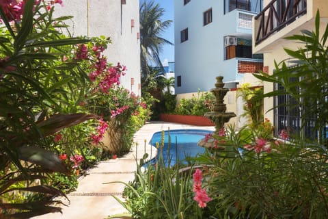 Secluded garden patio with refreshing common area pool retreat