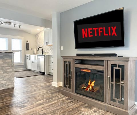 Enjoy Netflix on a 65" smart TV. Cozy up by the indoor fireplace or relax on the leather sofa!