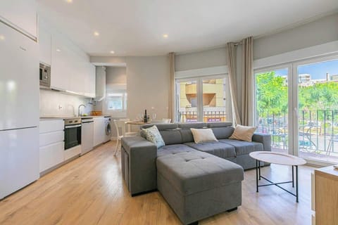 Spacious open living area with comfy sofa, kitchen, and dining for guests to enjoy.