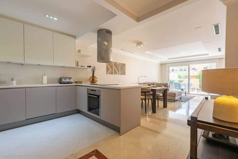 Sleek, modern kitchen with ample space, stylish decor, and natural light—perfect for preparing meals and gathering.







